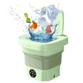 Green washing machine with clothes and water splashes on a white background